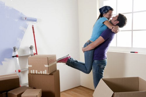 Packing and moving office furniture in a west London workspace