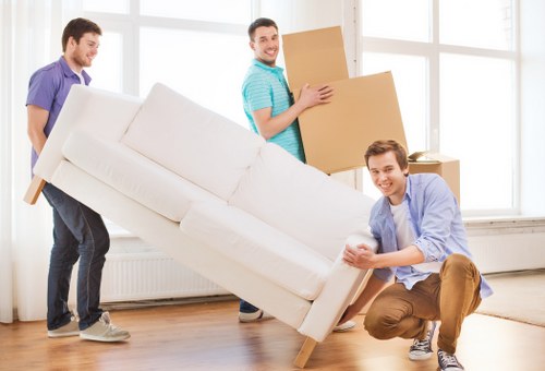 Removal staff carrying items carefully during a move