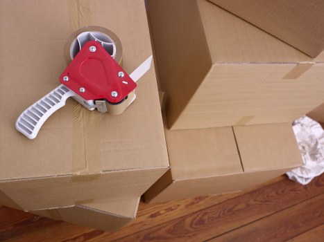 Removal team carrying furniture through a Notting Hill property staircase